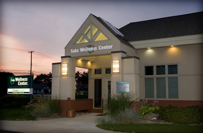exterior picture of Saks Wellness Center in Gaylord, Michigan - this picture of the Main Entrance taken at dusk with with building's exterior lights on