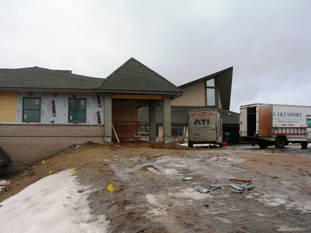 picture of front elevation - the Church Addition is in the foreground and the existing Church is visible in the background - windows on addition have been installed