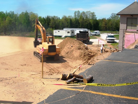 picture of excavation equipment working at the site for an addition to Word of Life Baptist Church in Alpena MI