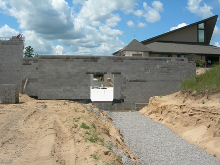 photo of concrete masonry unit wall for Addition being built at Word of Life Baptist Church in Alpena, Michigan - view from side/front elevation - the main entry of the Church is visible in the background