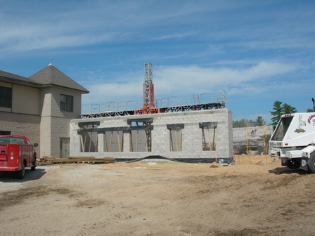 picture of rear elevation of Word of Life Church - concrete masonry unit foundation wall for the the lower level of the addition is underway