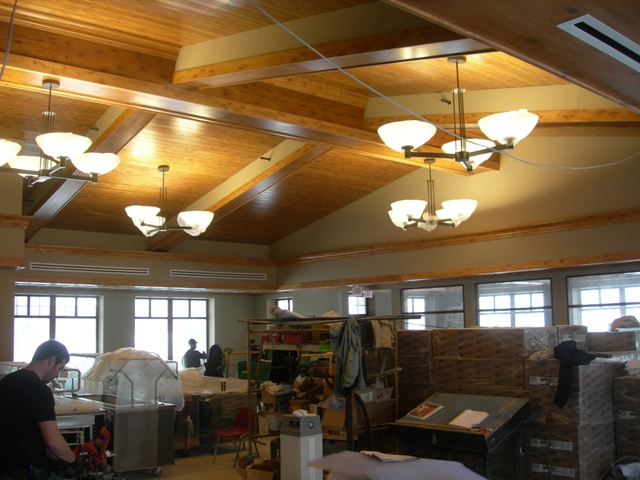 picture of interior of dining hall under construction with wood beam and plank ceiling
