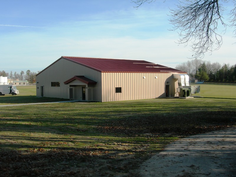 exterior picture of Medical Readiness Training Site Facility - tan siding with red metal roof