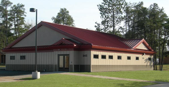 exterior picture of Visiting Unit Medical Facility - tan siding with red metal roof