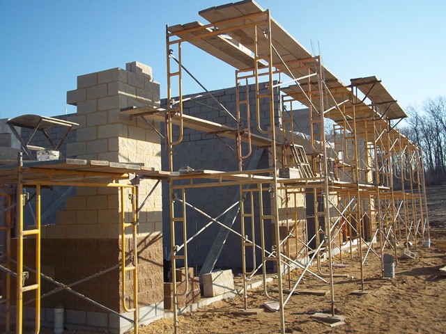 scaffolding in front of concrete masonry wall construction
