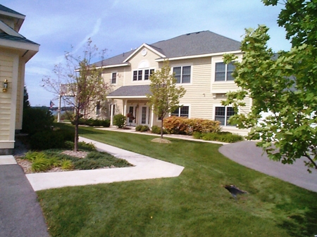 picture of Harborage Bay Waterfront Condominiums in Boyne City, Michigan - yellow siding, white trim, grey shingled roofs