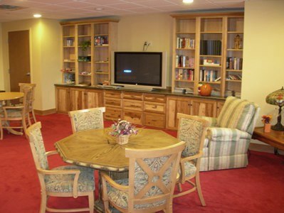 interior picture is of the one of  the community gathering spaces at Freighter View Assisted Living Facility in Sault Ste. Marie, Michigan - custom built-ins and media center