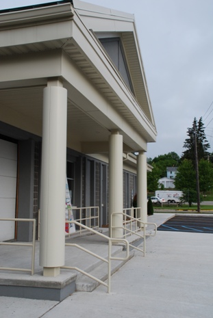 exterior picture of Main Entrance - covered entry, columns and barrier-free ramp for Littlefield Alanson Community Library