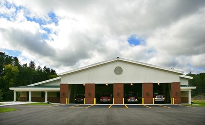 picture of Apparatus Bay with doors open showing fire trucks and EMS truck at Littlefield Township Fire Station, Alanson, Michigan