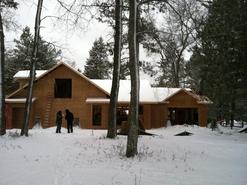 Lake Margrethe home has exterior sheathing almost complete with openings cut for doors and windows.