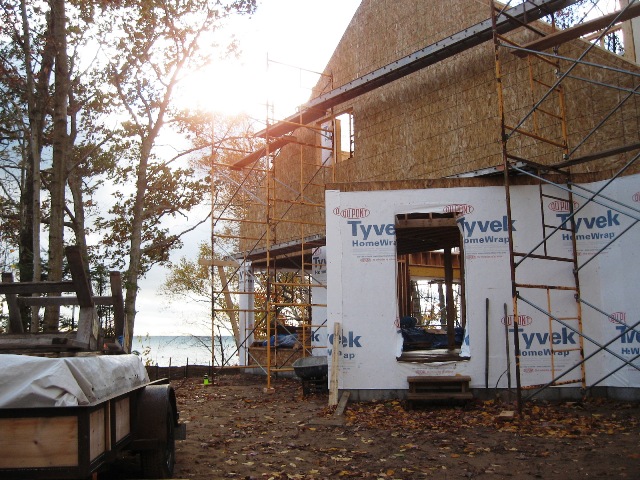 picture of scaffolds around home being built with Lake Michigan in background