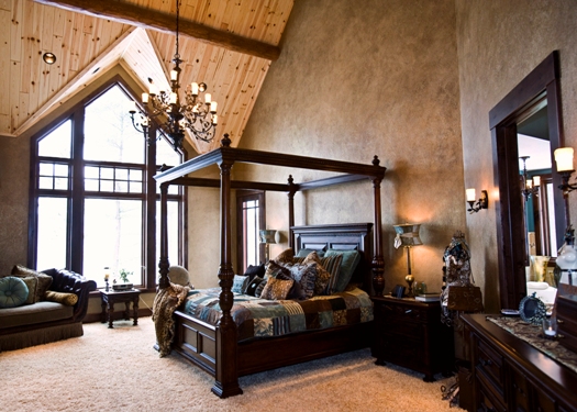 photo of master bedroom with high wood ceilings and textured paint walls