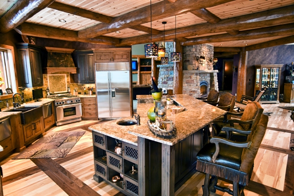 this interior photo is of the gourmet kitchen, with center island, wood beam and plank ceiling which mirrors the pattern in the planked wood floor