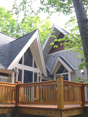 picture of one of the many decks for a waterfront home on Kassuba Lake - the home's A-Frame design is replicated in the design of the roof peaks over the main entrance and side windows
