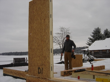 picture of workman installing the first SIP panel on a custom home being built on Otsego Lake in Gaylord, Michigan