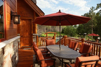 picture of second level outdoor deck overlooking swimming pool and spa at Ward Lake Residence in Gaylord, Michigan