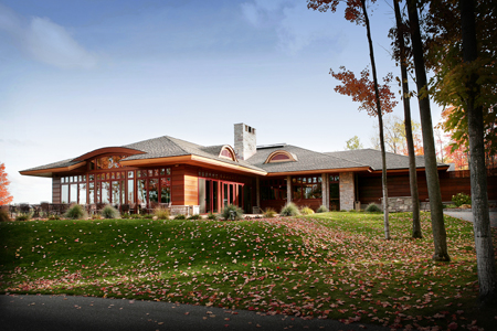 exterior picture of UAW Black Lake Golf Course Clubhouse - dark wood siding with wood trim and stone accents, grey shingle roof